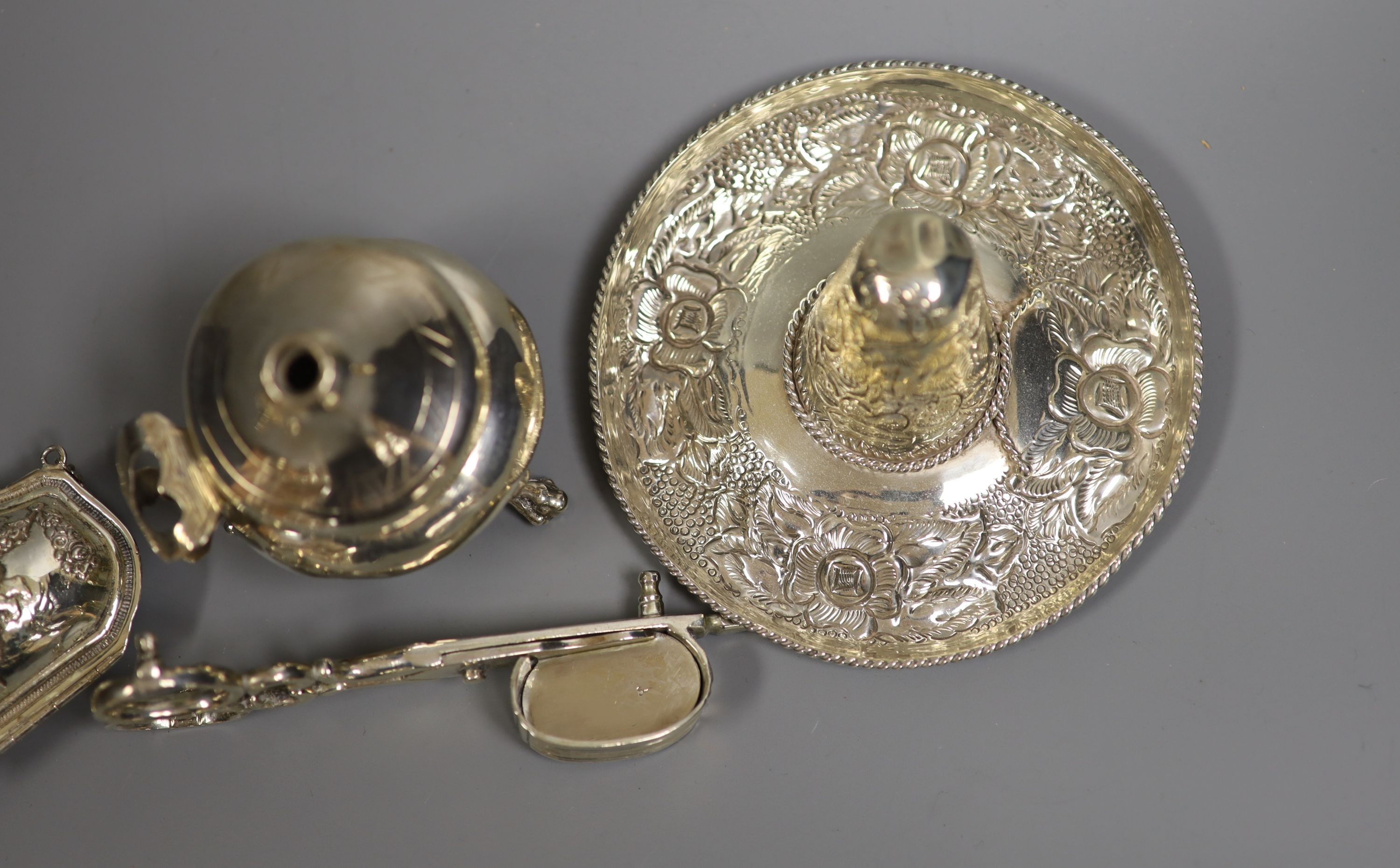 A sterling miniature sombrero and three other items, including candle snuffers and purse